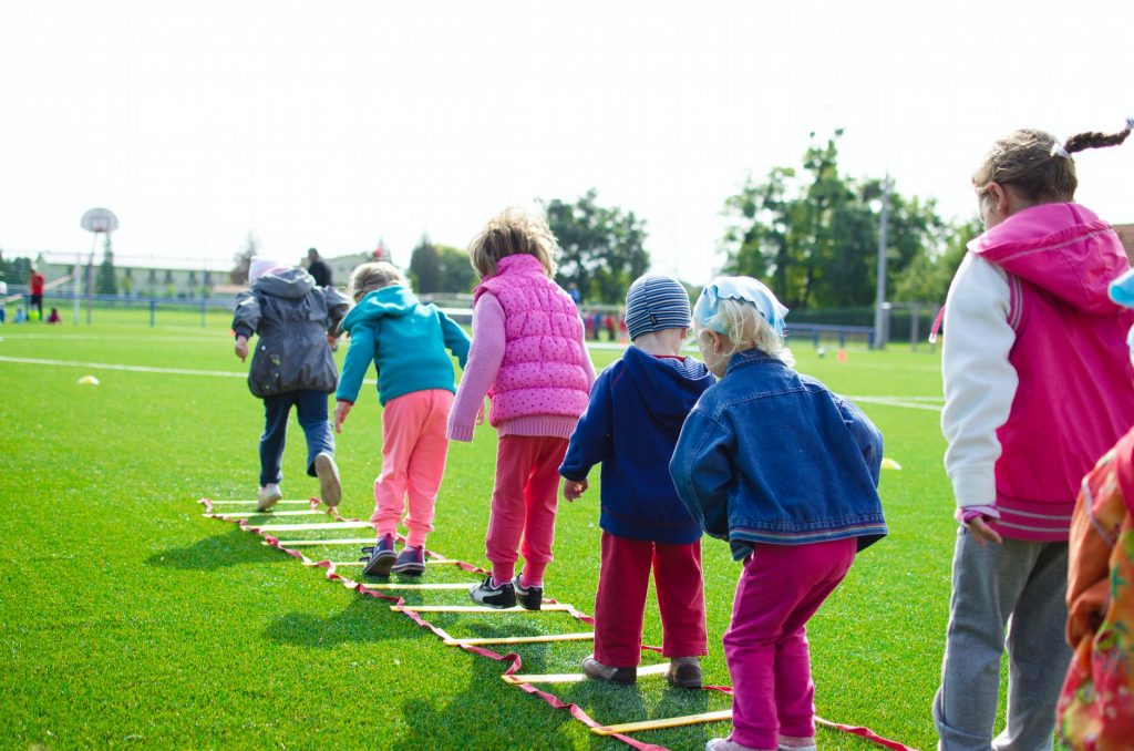 children-playing-teach-hearing-loss A group of children playing outside.
