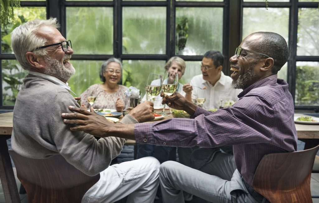 Friends-dinner party-hearing loss-hearing aids Friends at a dinner party.